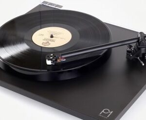 A record player with the lid open and its arm extended.