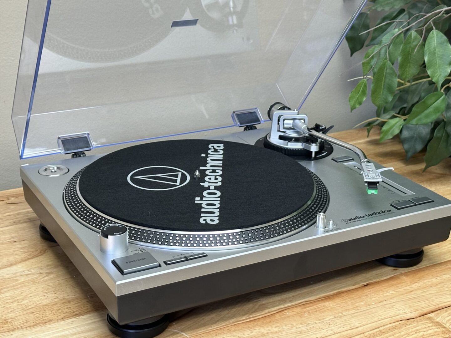 A turntable record player on a wooden surface.